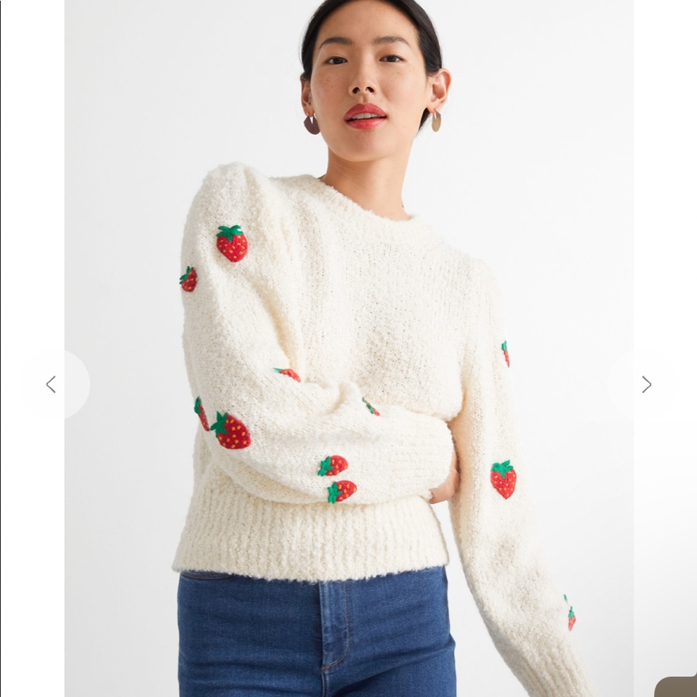 A soft and cozy sweater with cute strawberries
